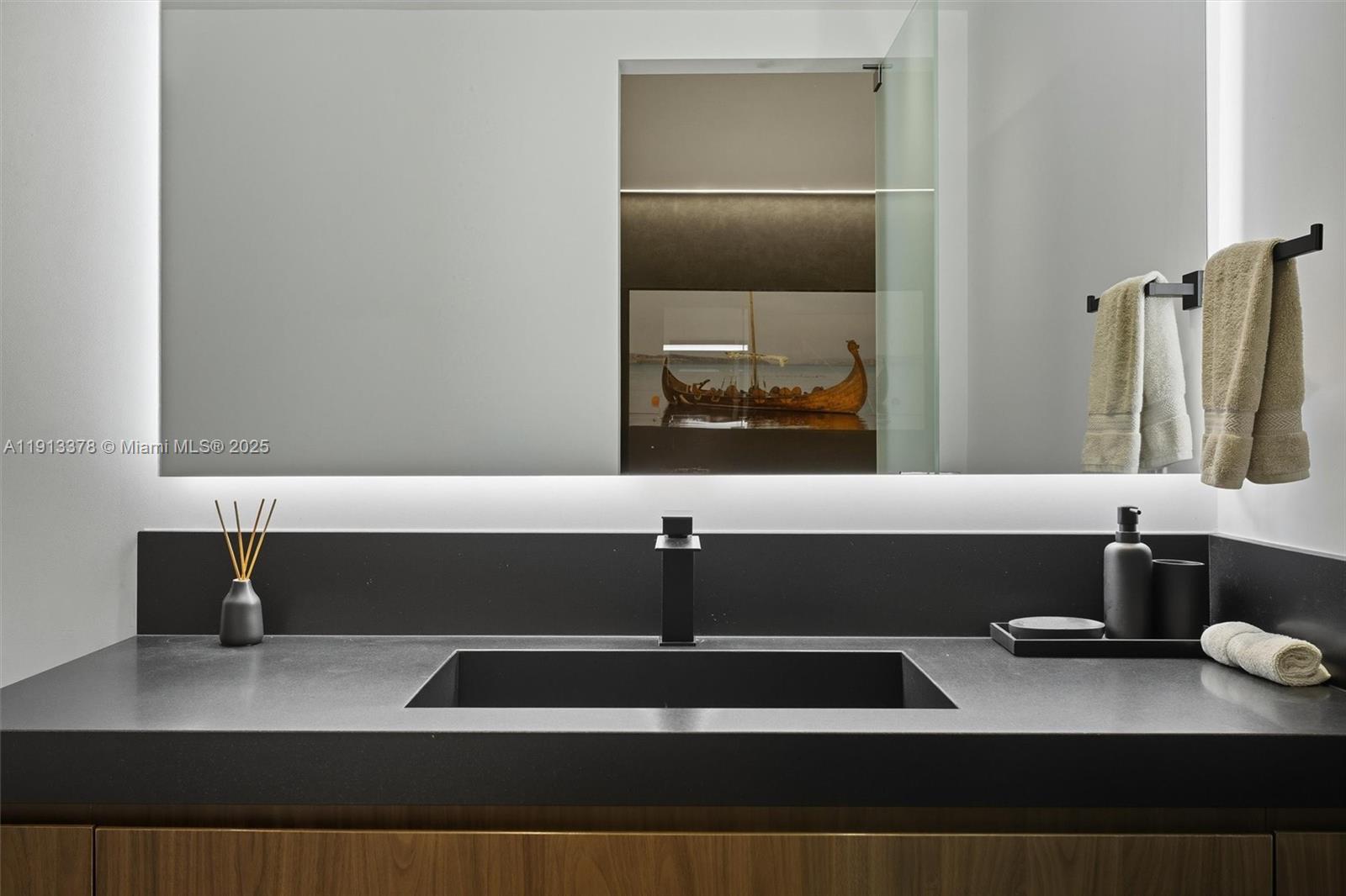 2301 Collins Avenue, Unit 1634 Miami Beach, FL 33139 - Photo 28 of 56 a bathroom with a sink and a mirror