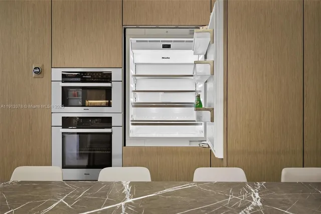 a living room with furniture a rug and a potted plant