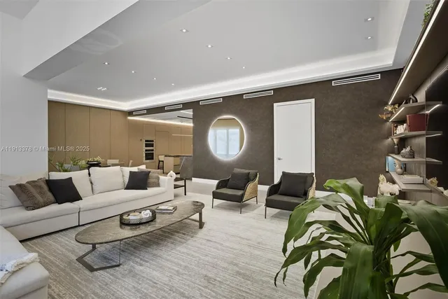 a living room with a couch and chandelier