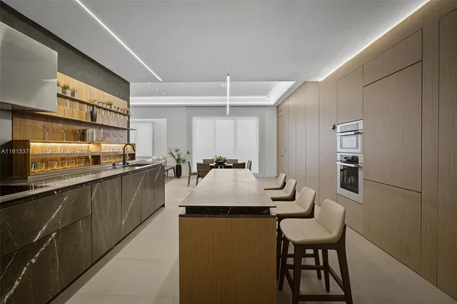 a kitchen with a table chairs refrigerator and cabinets