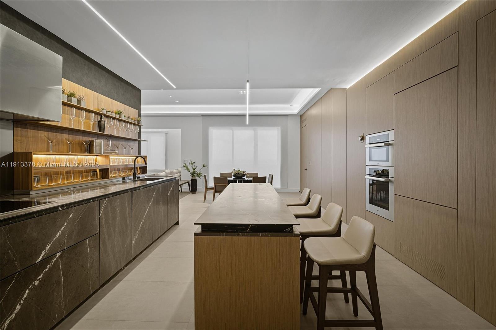 2301 Collins Avenue, Unit 1634 Miami Beach, FL 33139 - Photo 48 of 56 a kitchen with a table chairs and a refrigerator