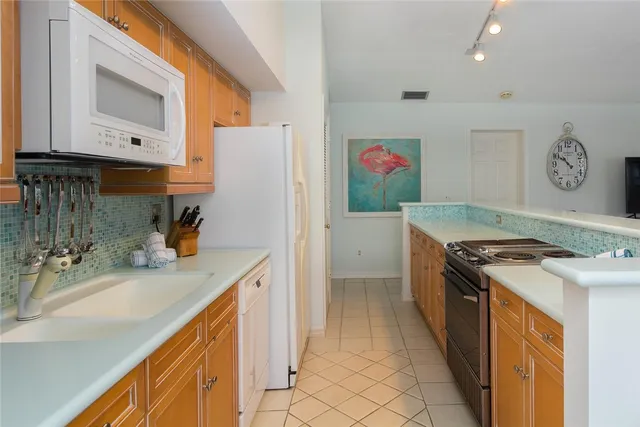 a dining room with furniture and a floor to ceiling window