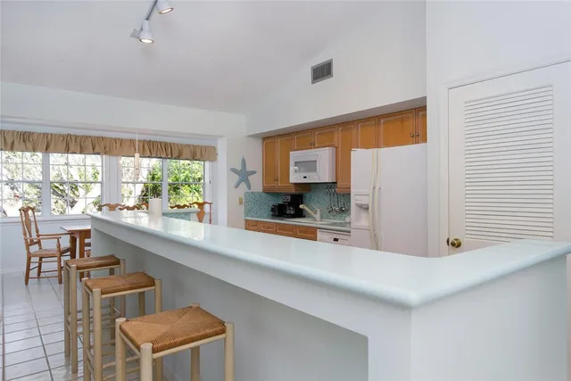 a dining room filled with furniture and window