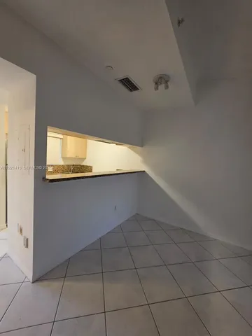 a view of a hallway to rooms