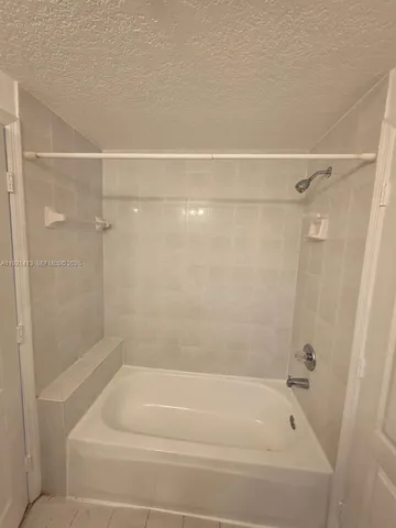 a bathroom with a shower and a bath tub