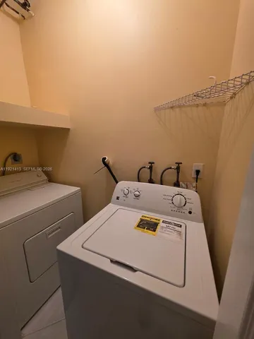 a utility room with dryer and washer