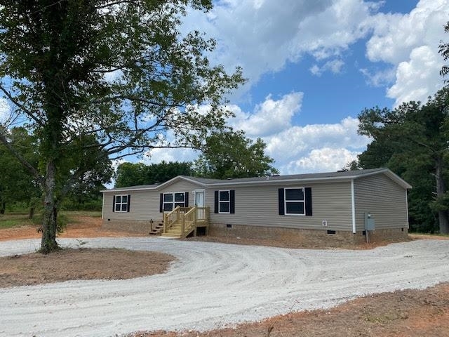 209 Lepard Road Waco, GA 30182 - Photo 1 of 1 a front view of house with yard and trees around