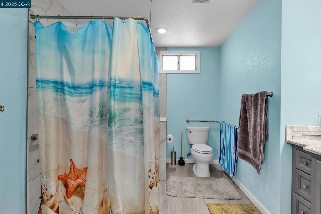 2113 Dalis Drive Concord, CA 94520 - Photo 17 of 22 a bathroom with a shower and a toilet