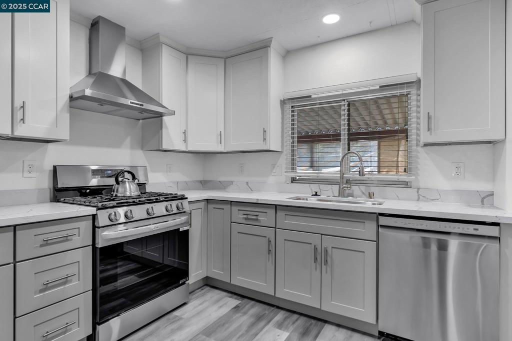 2113 Dalis Drive Concord, CA 94520 - Photo 6 of 22 a kitchen with granite countertop white cabinets and a stove