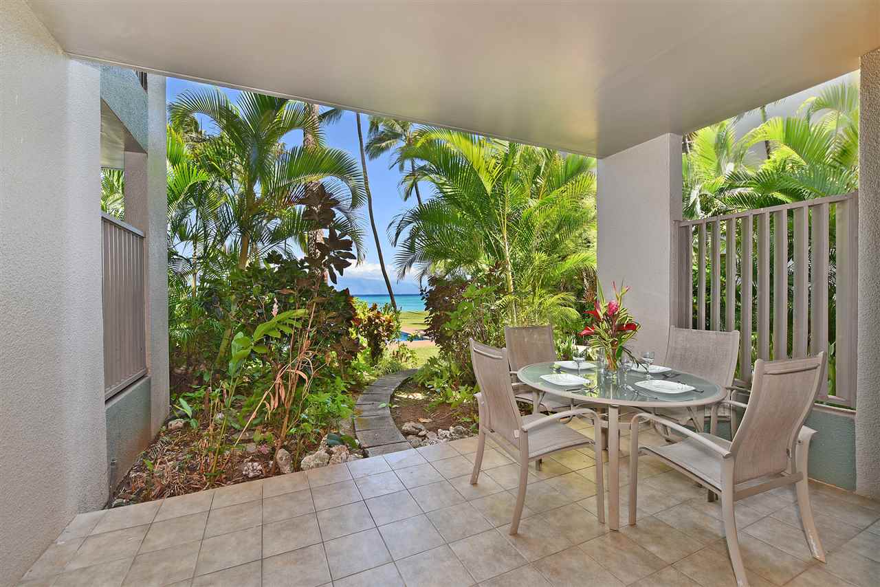 a view of a chairs and table in a backyard