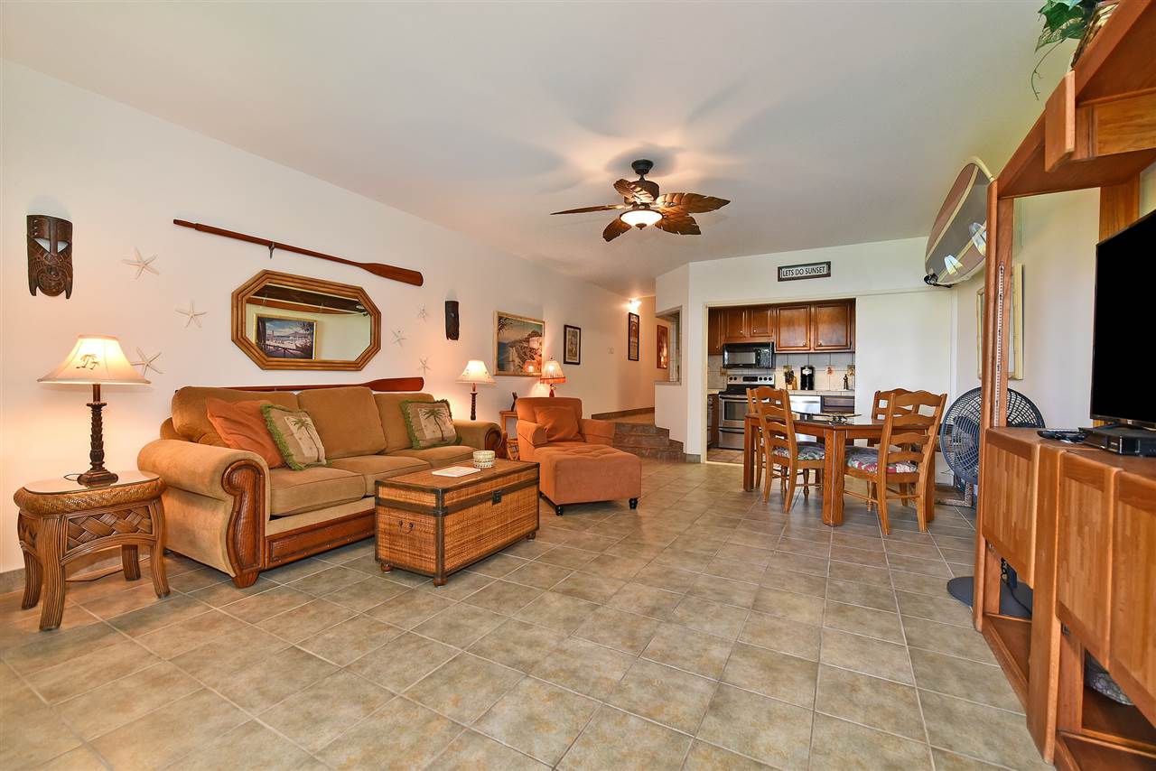 3875 Lower Honoapiilani Road, Unit B103 Lahaina, HI 96761 - Photo 11 of 30 a living room with furniture kitchen view and a flat screen tv