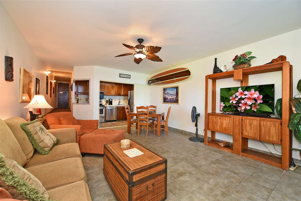 3875 Lower Honoapiilani Road, Unit B103 Lahaina, HI 96761 - Photo 12 of 30 a living room with furniture a dining table and a fireplace