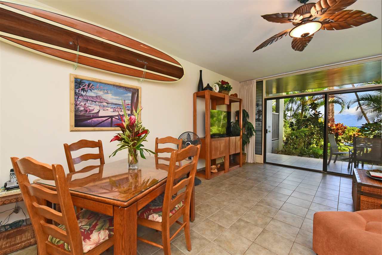 3875 Lower Honoapiilani Road, Unit B103 Lahaina, HI 96761 - Photo 14 of 30 a dining room with furniture and a floor to ceiling window
