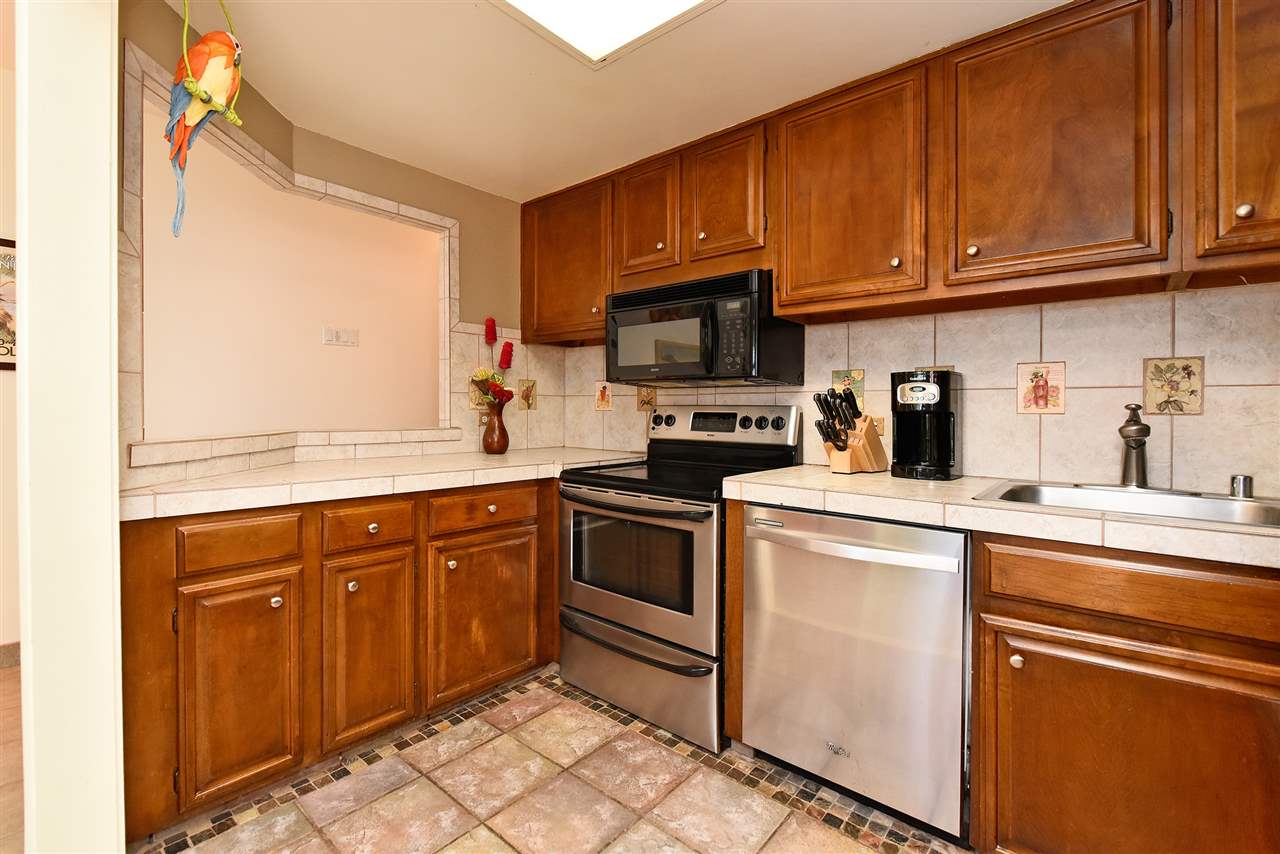 3875 Lower Honoapiilani Road, Unit B103 Lahaina, HI 96761 - Photo 18 of 30 a kitchen with granite countertop a sink stainless steel appliances and cabinets