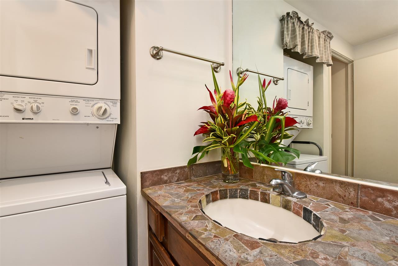 3875 Lower Honoapiilani Road, Unit B103 Lahaina, HI 96761 - Photo 26 of 30 a bathroom with a granite countertop sink a mirror and a shower