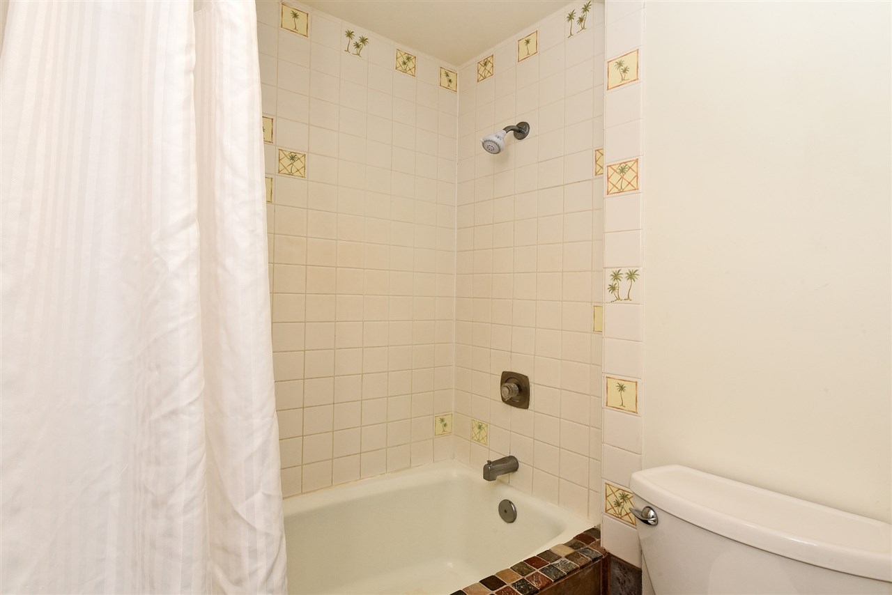 3875 Lower Honoapiilani Road, Unit B103 Lahaina, HI 96761 - Photo 27 of 30 a bathroom with a shower and a toilet