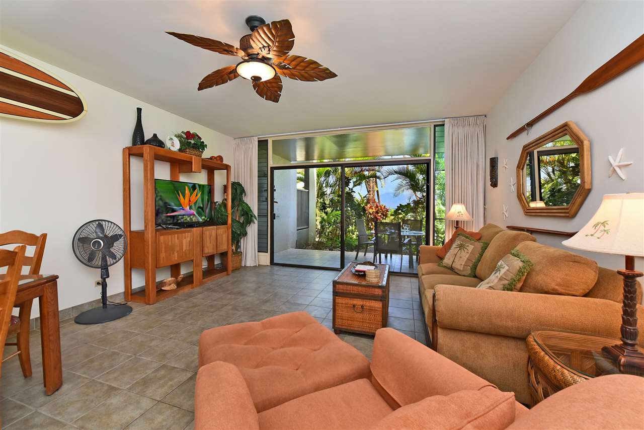 3875 Lower Honoapiilani Road, Unit B103 Lahaina, HI 96761 - Photo 7 of 30 a living room with furniture a ceiling fan and a window