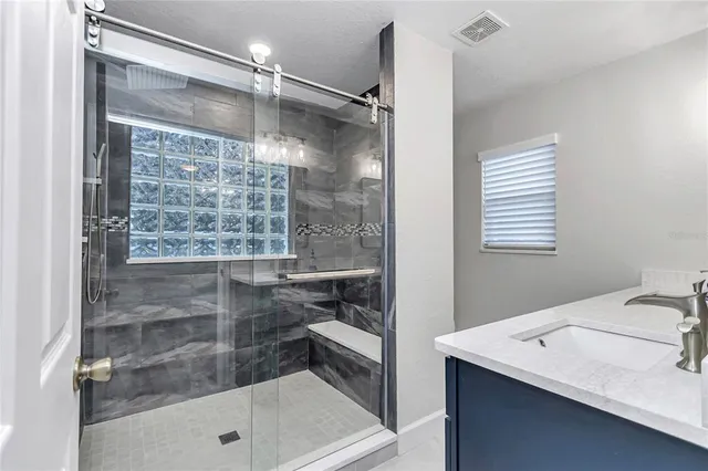 a white toilet sitting next to a shower