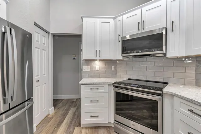 a view of a livingroom with wooden floor and a window