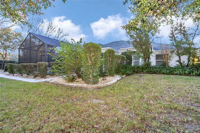 a aerial view of a house with a yard and large tree