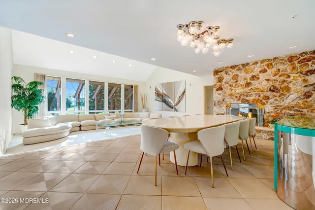 a view of a dining room with furniture and a large window