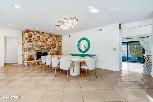 a view of a dining room with furniture and chandelier