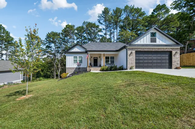 a front view of a house with a yard and garage