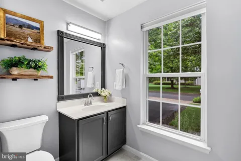 a bathroom with a toilet sink and mirror