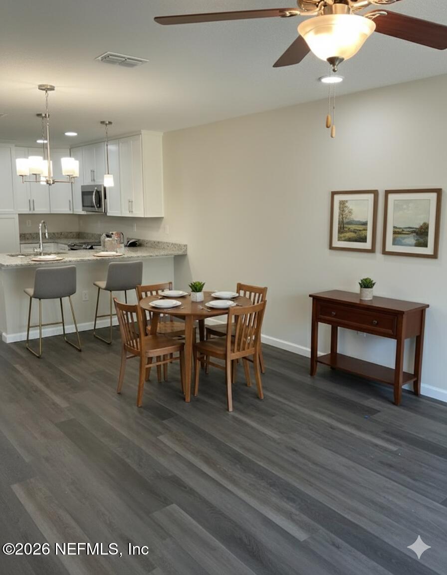 2783 Larsen Road Jacksonville, FL 32207 - Photo 4 of 4 a view of a dining room with furniture and wooden floor
