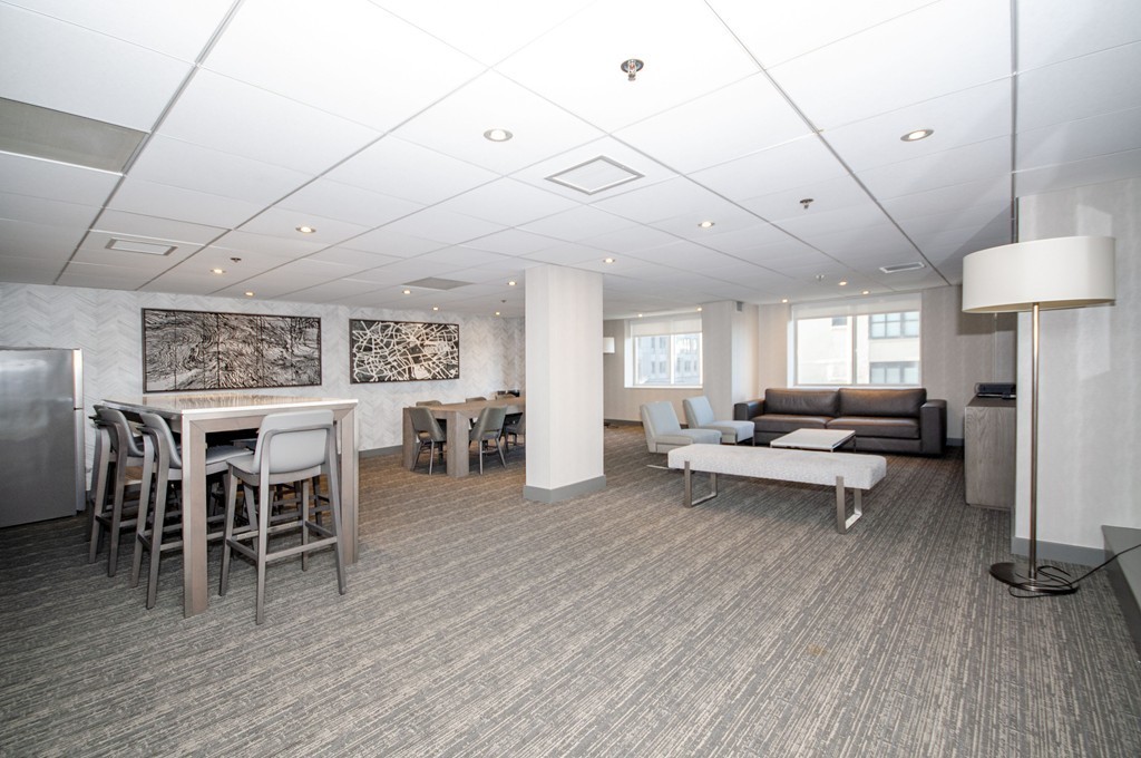 10 Museum Way, Unit 1521 Cambridge, MA 02141 - Photo 18 of 21 a living room with furniture a wooden floor and a fireplace