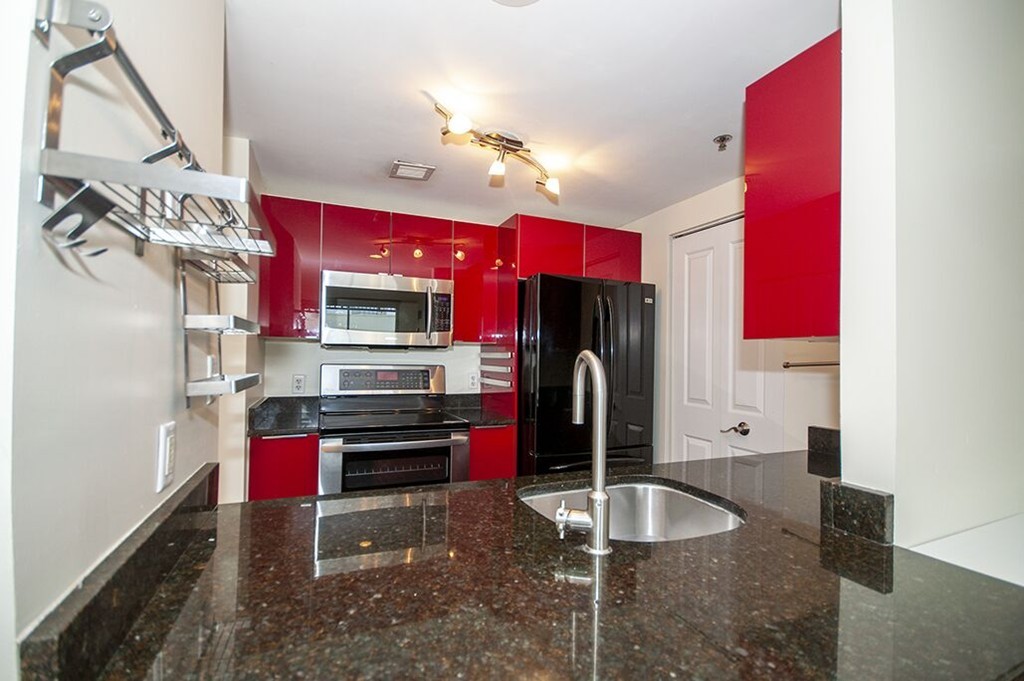 10 Museum Way, Unit 1521 Cambridge, MA 02141 - Photo 6 of 21 a kitchen with stainless steel appliances granite countertop a refrigerator and a sink