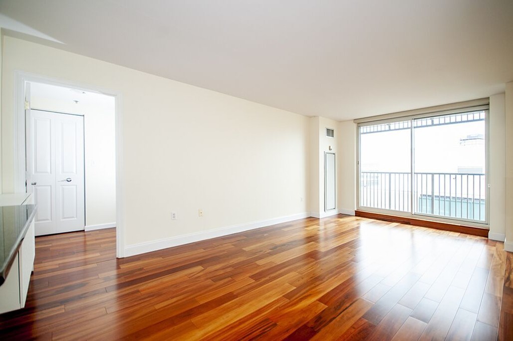 10 Museum Way, Unit 1521 Cambridge, MA 02141 - Photo 8 of 21 a view of an empty room with wooden floor and a window
