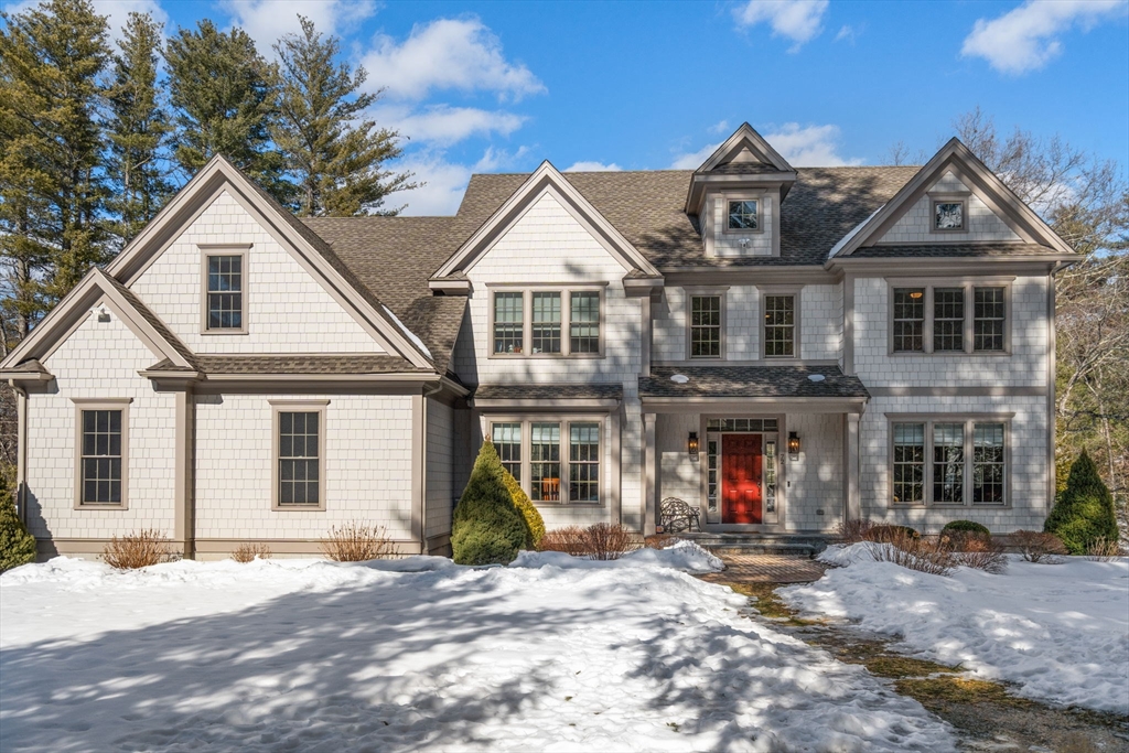 72 Moore Road Wayland, MA 01778 - Photo 1 of 23 a view of a white house with large windows and a yard