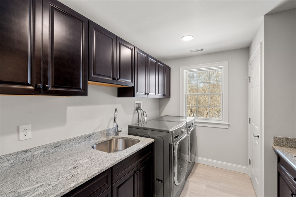 72 Moore Road Wayland, MA 01778 - Photo 15 of 23 a kitchen with granite countertop stainless steel appliances a sink stove top oven and cabinets