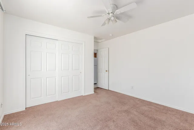 an empty room with a ceiling fan