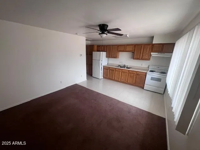 a kitchen with a refrigerator and a sink