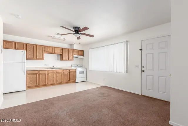 a view of a kitchen with a sink and a window