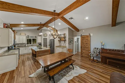 a spacious bathroom with a granite countertop sink a mirror and a shower