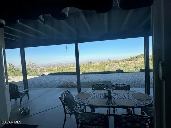 a view of a patio with a table chairs and a table