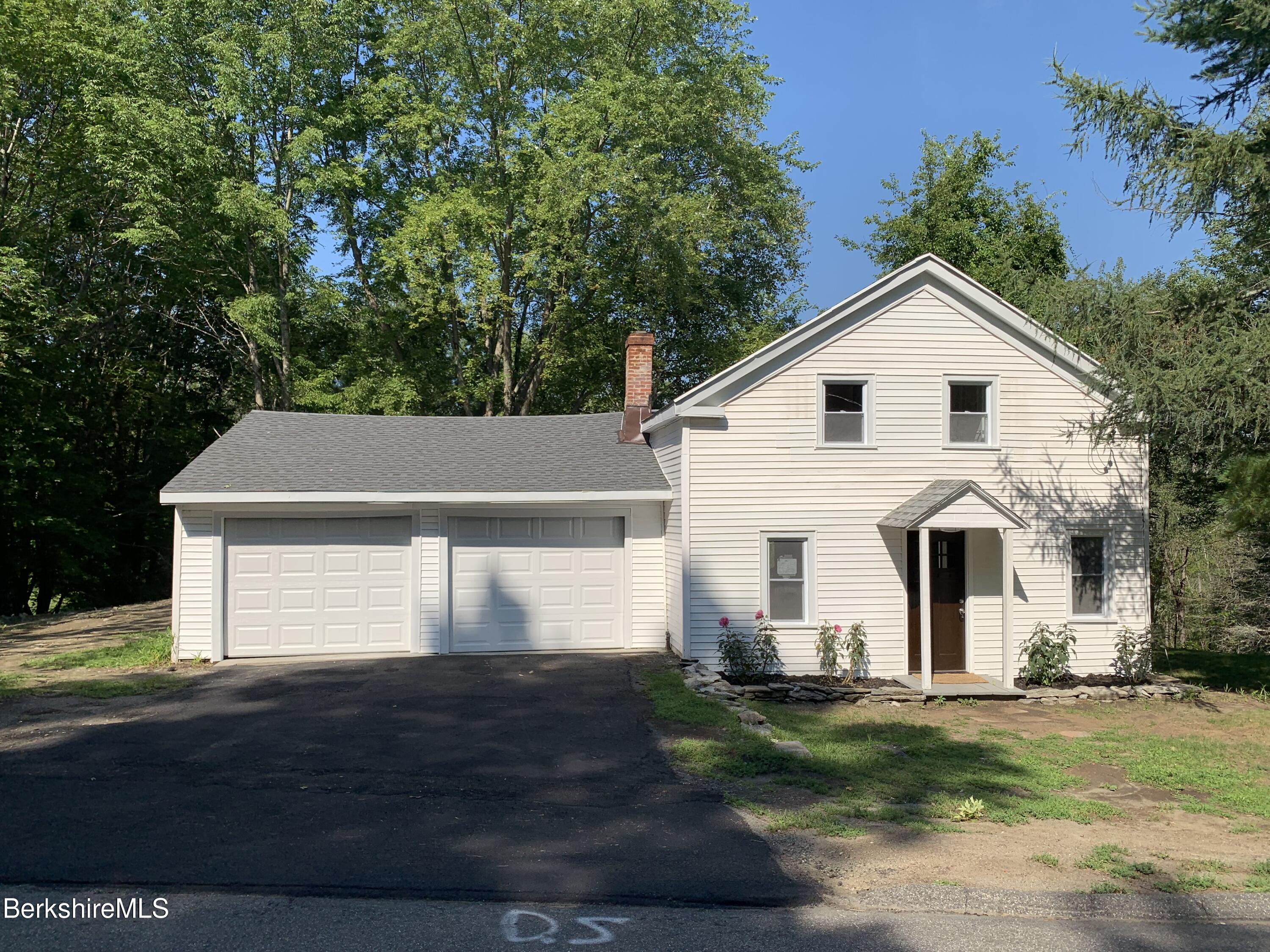 2312 State Road Richmond, MA 01254 - Photo 1 of 37 a front view of a house with a yard and garage