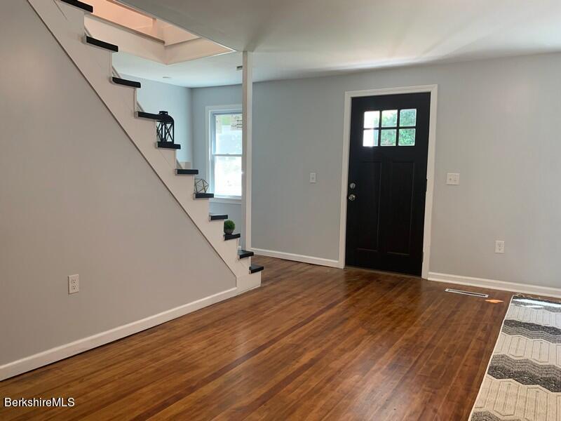 2312 State Road Richmond, MA 01254 - Photo 12 of 37 a view of an empty room with stairs and a window