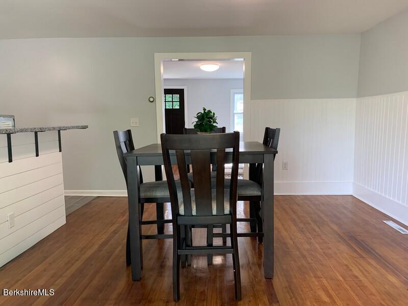 2312 State Road Richmond, MA 01254 - Photo 17 of 37 a view of a dining room with furniture and wooden floor