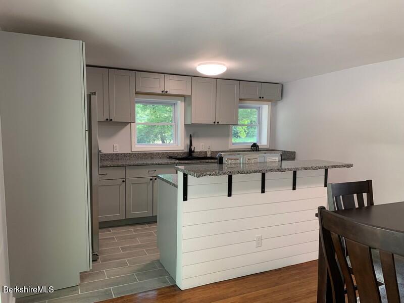 2312 State Road Richmond, MA 01254 - Photo 20 of 37 a kitchen with granite countertop a stove a sink and a refrigerator