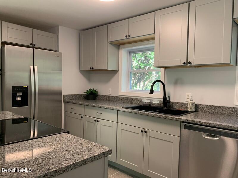 2312 State Road Richmond, MA 01254 - Photo 22 of 37 a kitchen with kitchen island granite countertop a sink stainless steel appliances and cabinets