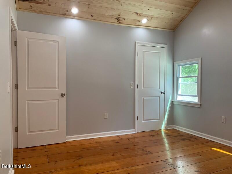 2312 State Road Richmond, MA 01254 - Photo 33 of 37 an empty room with wooden floor and closet