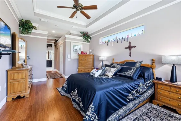 a bedroom with bed and wooden floor