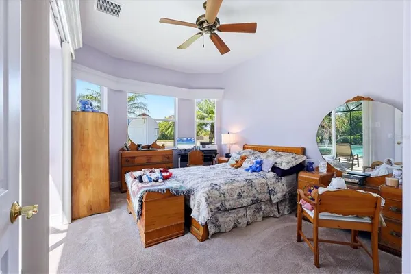 a bedroom with furniture and a large window