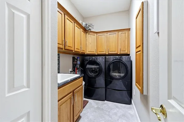 a utility room with sink dryer and washer