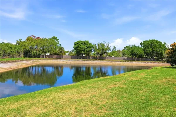 a view of a lake with houses in the background