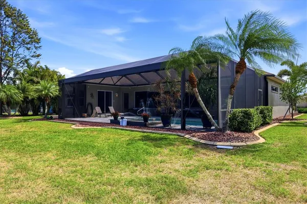 a view of a house with swimming pool and sitting area